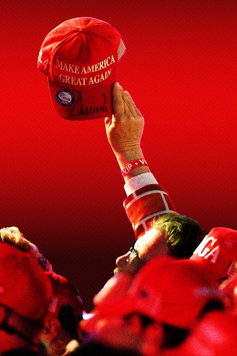 a hand holding up a maga hat